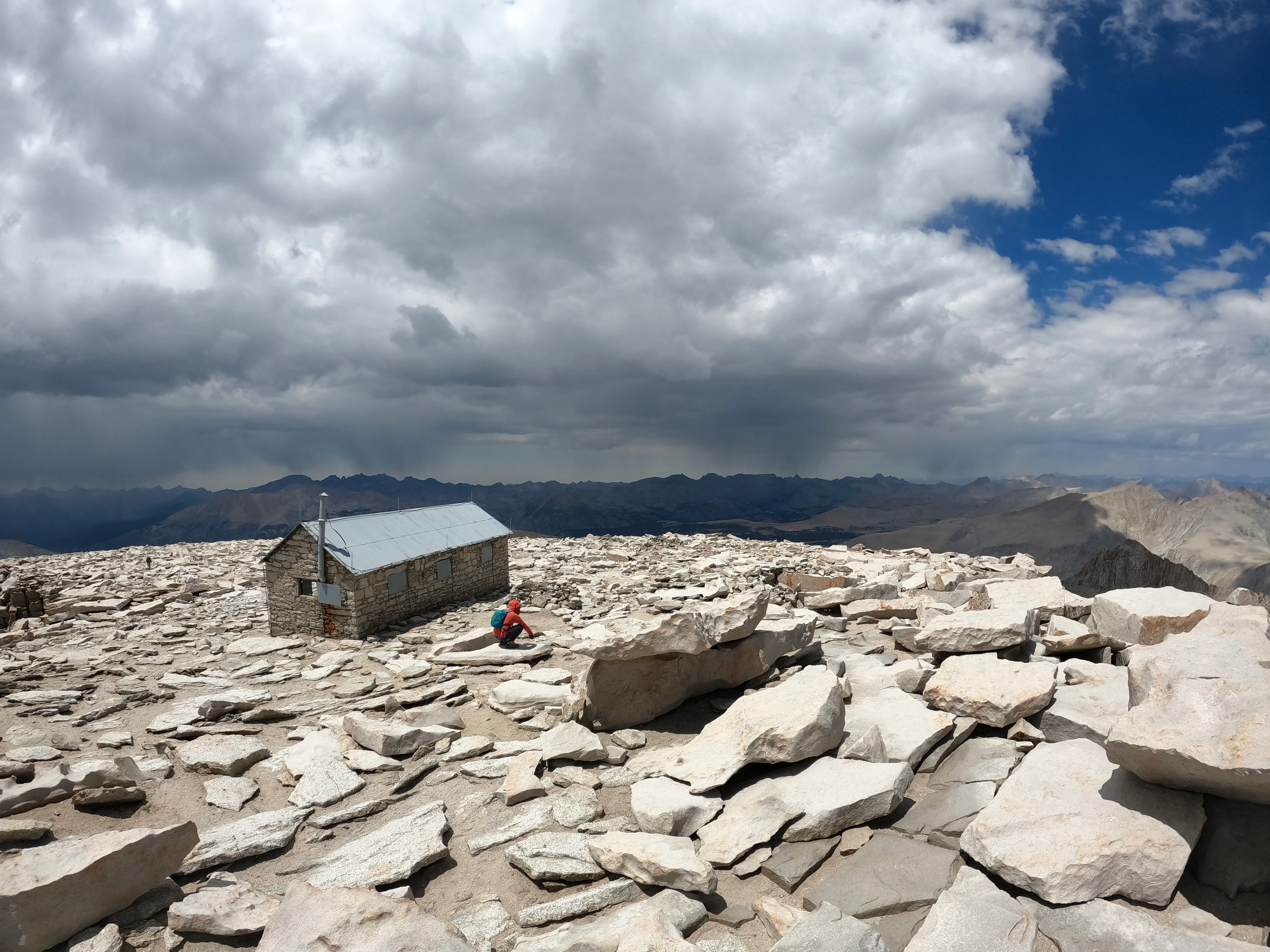 Elliott and Jeremy on the summit of Mount Whitney at 14,505 feet, holding the summit signs