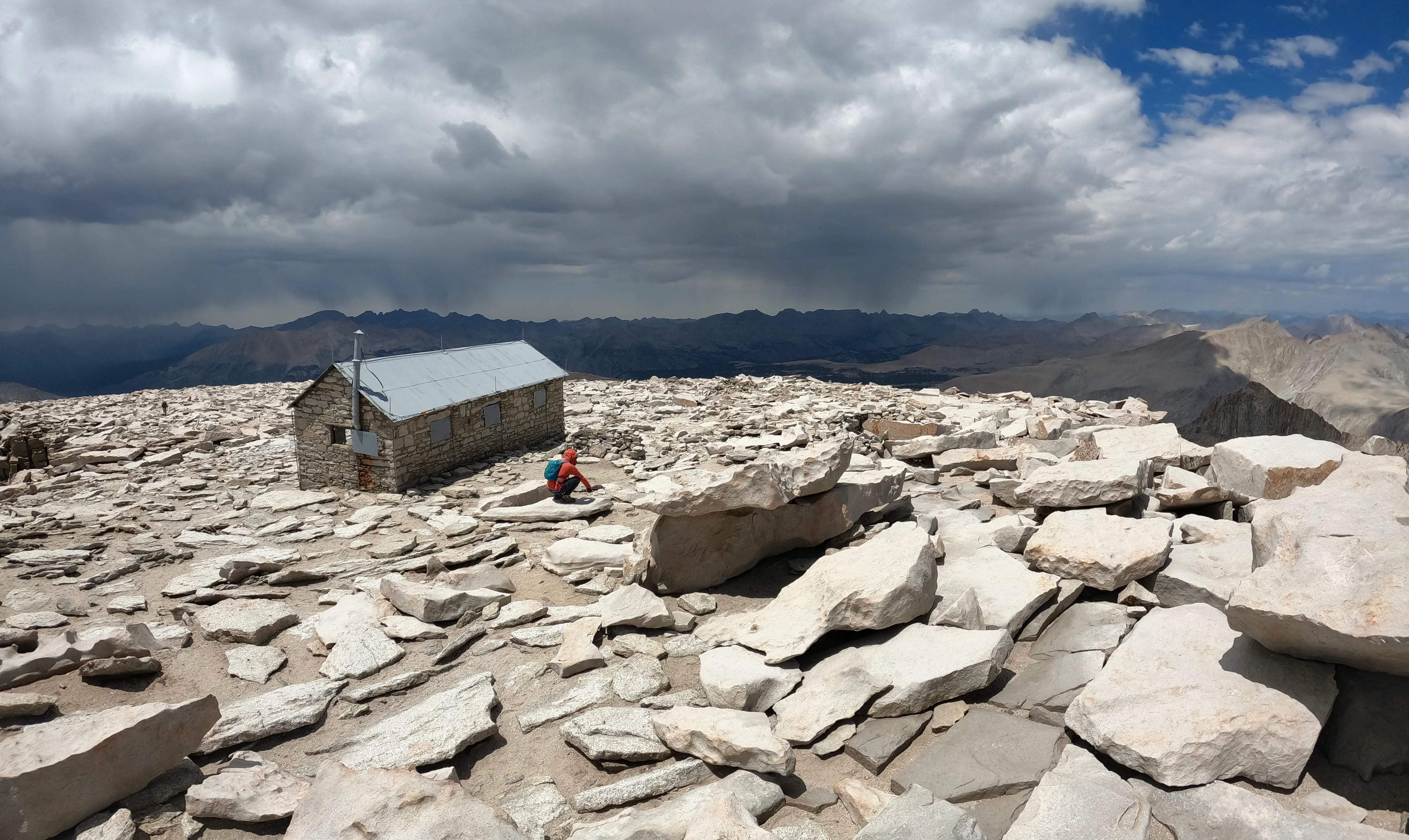 Elliott and Jeremy on the summit of Mount Whitney at 14,505 feet, holding the summit signs